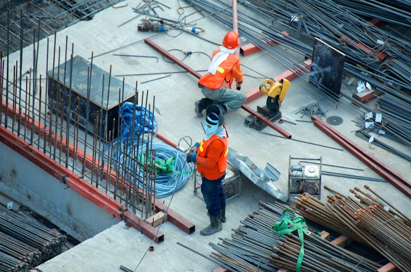 Construction workers laying steel reinforcement on site