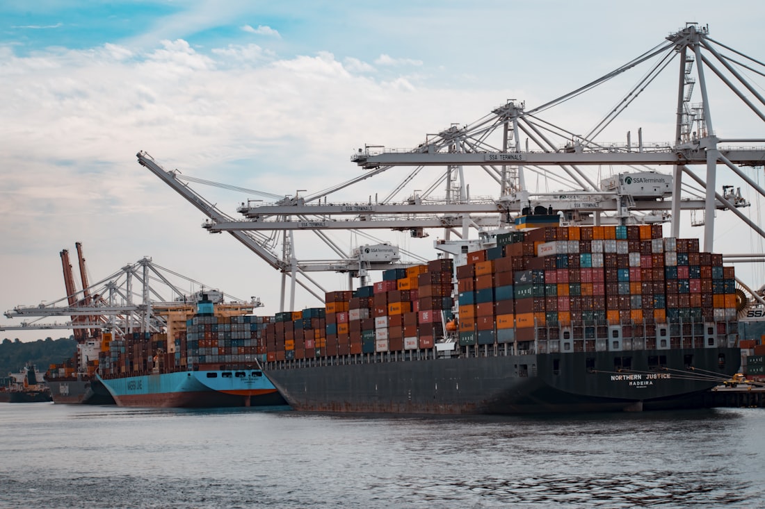 Container vessel being loaded by quayside cranes at port
